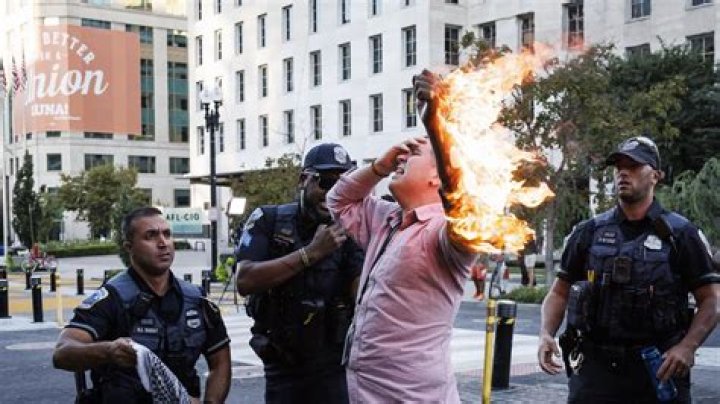 Horrifying moment man dressed as grim reaper sets himself on FIRE in holiday resort - as tourists watch and take selfies