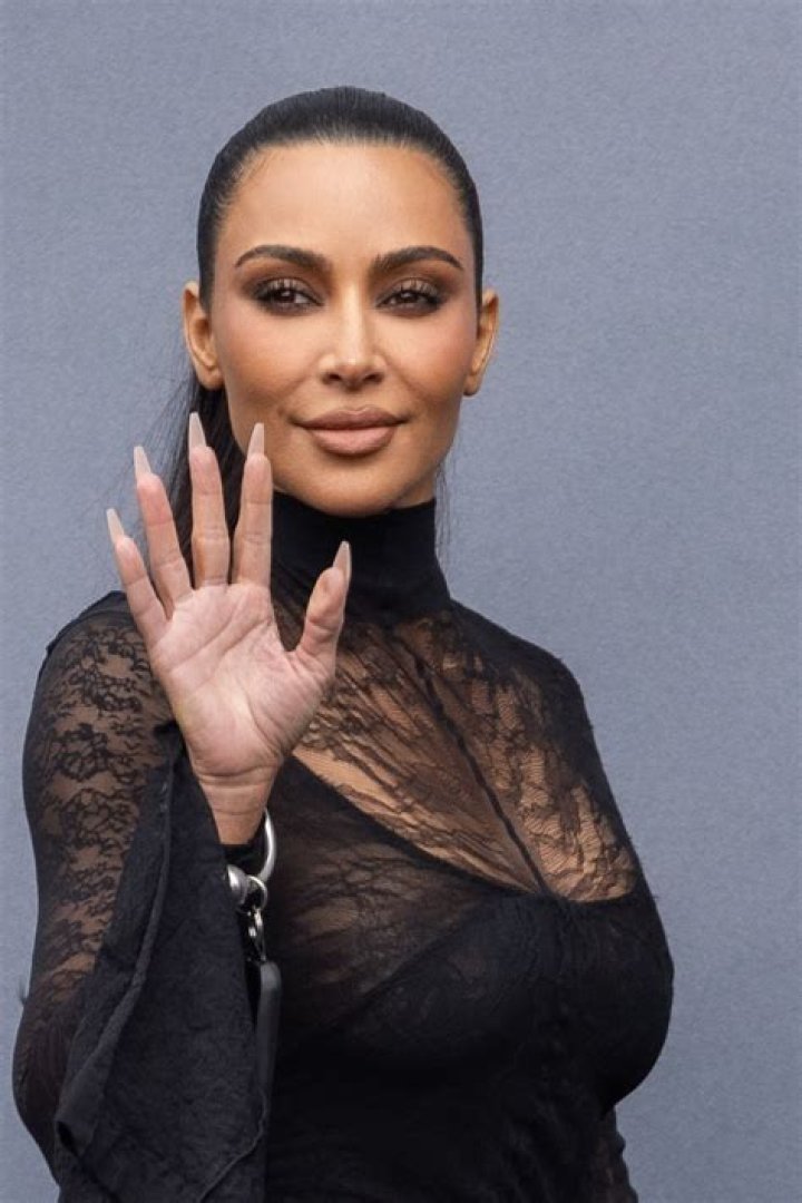 Kim Kardashian shows off her famous bum in a tight red unitard
