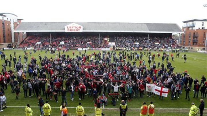 Leyton Orient fans storm the field at Brisbane Road as match against Colchester is stopped