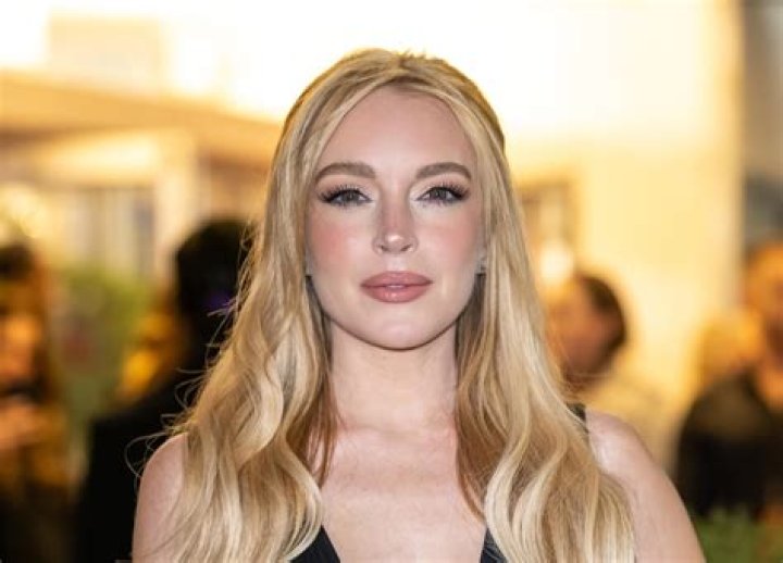 Lindsay Lohan shows off her cleavage in plunging red Baywatch style swimsuit as she soaks up the sun on Greek island of Mykonos