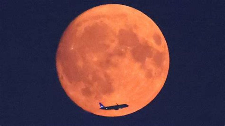 Stunning red 'Hunter's Moon' graces night skies across the globe to signal start of Autumn