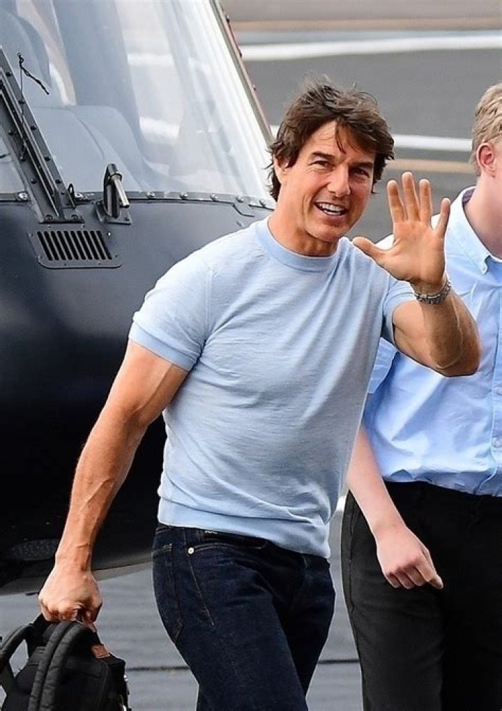 Tom Cruise flashes a big smile after flying himself in a helicopter