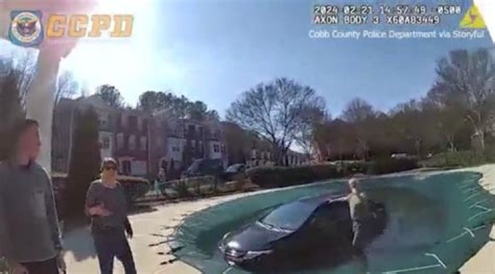 WATCH: Woman pulled from car after driving into swimming pool